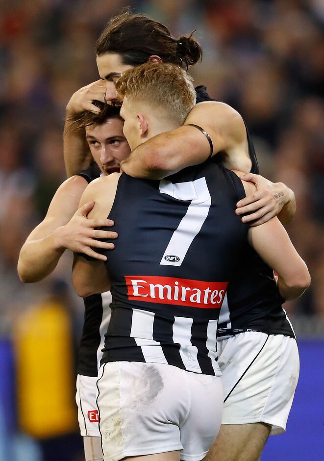 AFL 2016 Rd 15 - Carlton v Collingwood MELBOURNE, AUSTRALIA - JULY 02: Brodie Grundy of the Magpies celebrates a goal with Adam Treloar and Tom Phillips of the Magpies during the 2016 AFL Round 15 match between the Carlton Blues and the Collingwood Magpies at the Melbourne Cricket Ground on July 2, 2016 in Melbourne, Australia. (Photo by Adam Trafford/AFL Media)